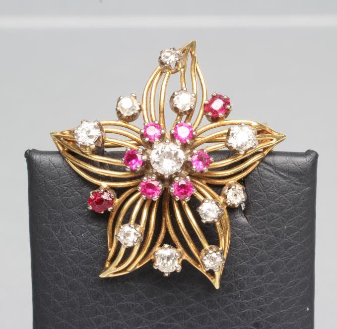 A DIAMOND AND RUBY OPENWORK FLOWER BROOCH Image