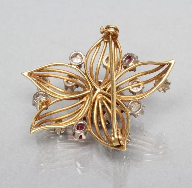 A DIAMOND AND RUBY OPENWORK FLOWER BROOCH Image
