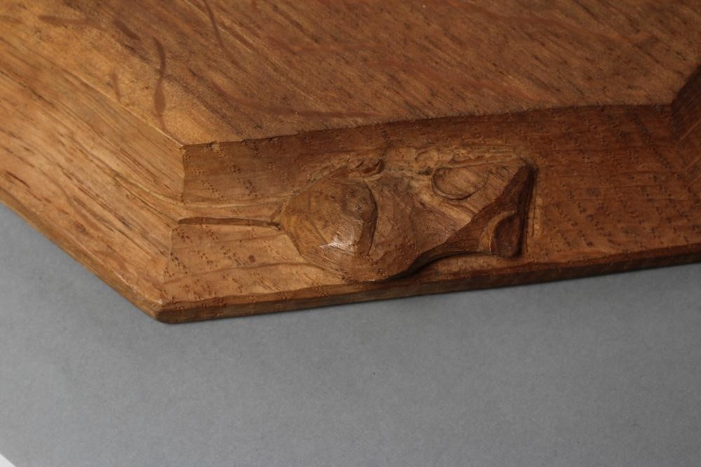 A ROBERT THOMPSON OAK CHOPPING BOARD of canted oblong form Image
