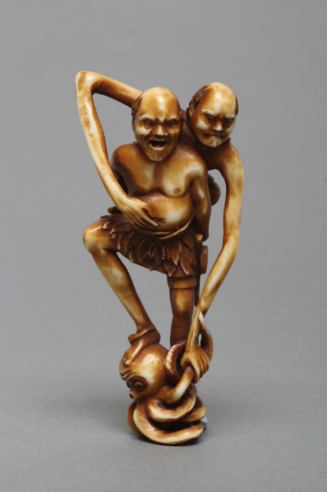 A JAPANESE STAINED IVORY NETSUKE Image