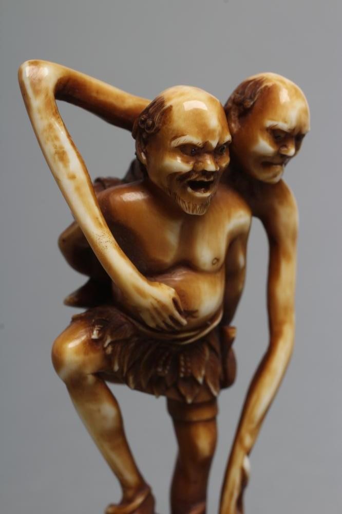 A JAPANESE STAINED IVORY NETSUKE Image