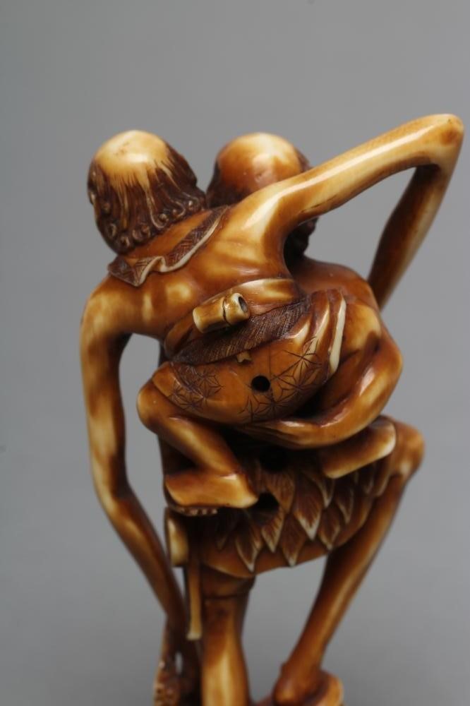 A JAPANESE STAINED IVORY NETSUKE Image