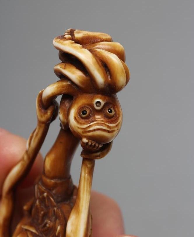 A JAPANESE STAINED IVORY NETSUKE Image