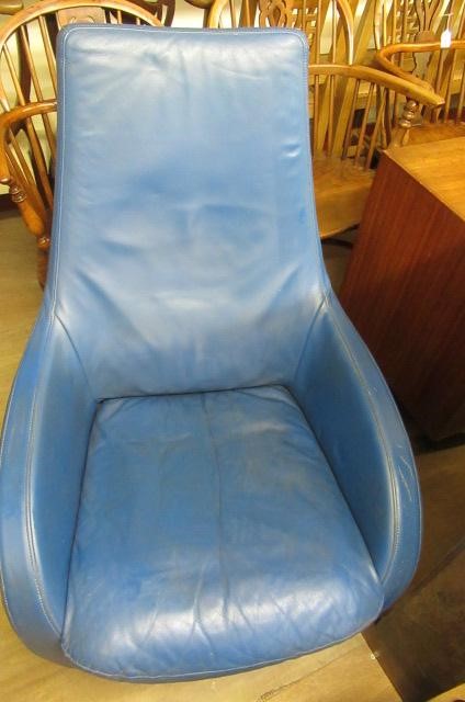 A ROLF BENZ BLUE LEATHER SWIVEL ARMCHAIR Image