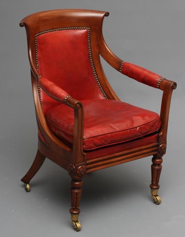 A WILLIAM IV MAHOGANY FRAMED BERGERE upholstered in red leather Image