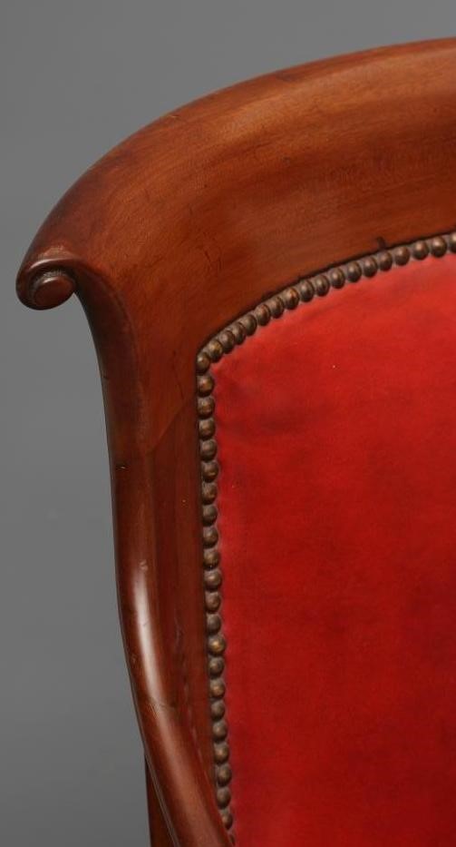 A WILLIAM IV MAHOGANY FRAMED BERGERE upholstered in red leather Image