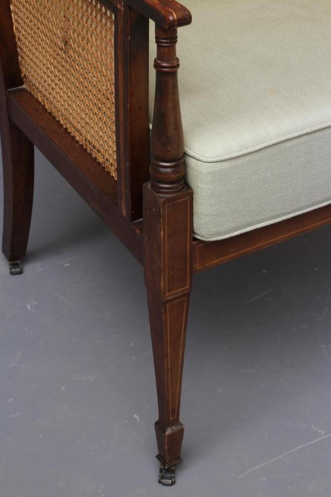 AN EDWARDIAN MAHOGANY AND CANED BERGERE with stringing Image