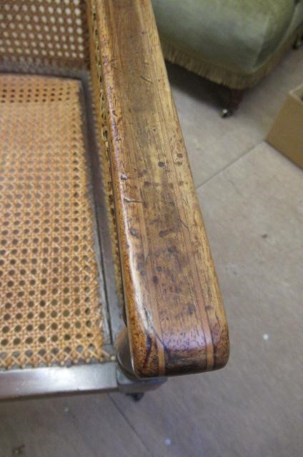 AN EDWARDIAN MAHOGANY AND CANED BERGERE with stringing Image