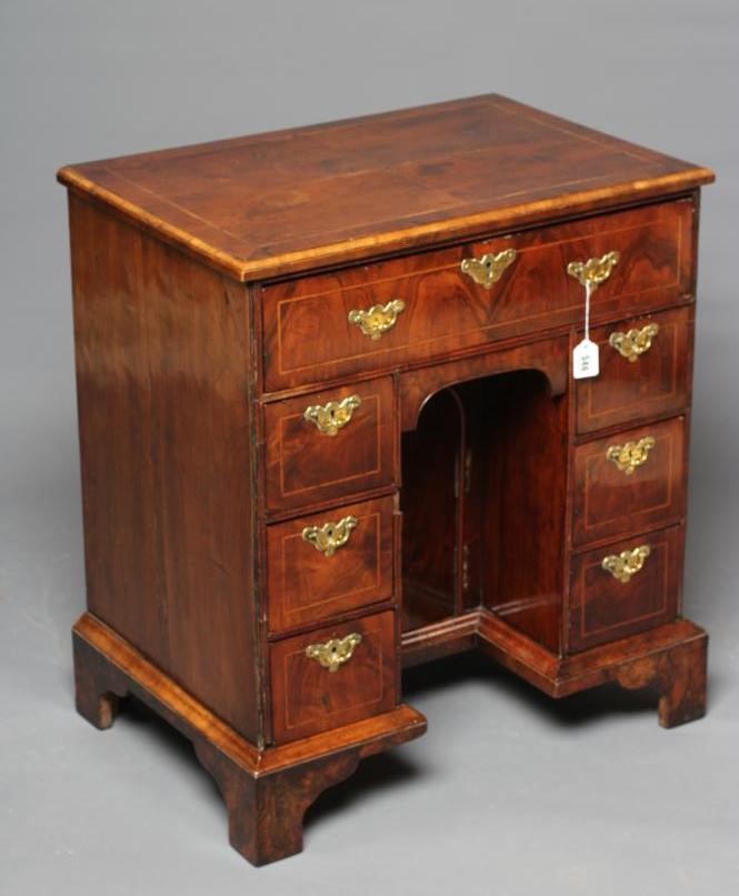 A GEORGE I AND LATER WALNUT KNEEHOLE DESK Image