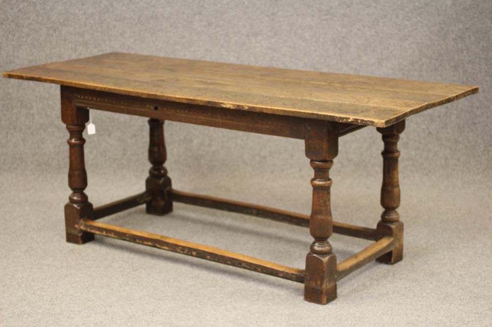 A JOINED OAK DINING TABLE Image