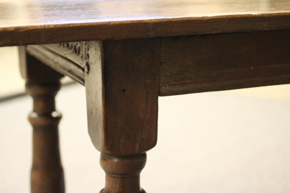 A JOINED OAK DINING TABLE Image