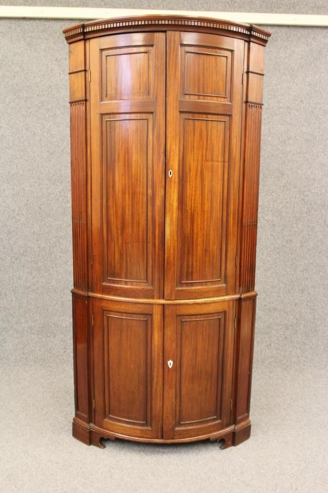 A GEORGIAN MAHOGANY BOWED STANDING CORNER CUPBOARD Image