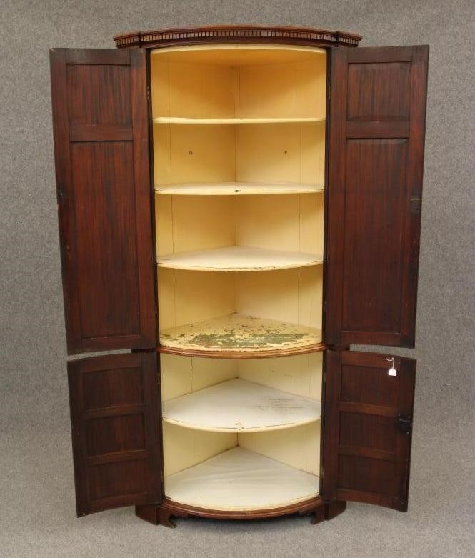 A GEORGIAN MAHOGANY BOWED STANDING CORNER CUPBOARD Image