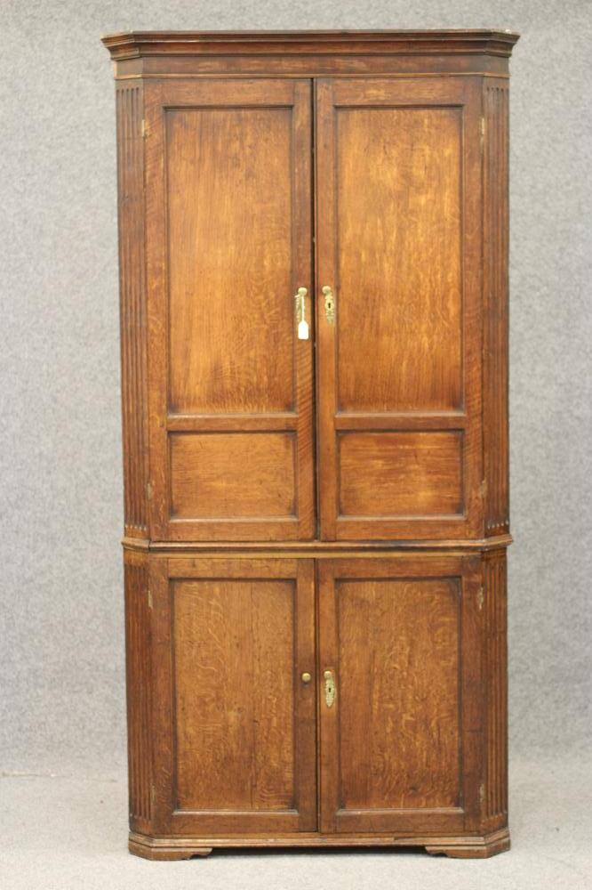 A GEORGIAN OAK STANDING CORNER CUPBOARD Image
