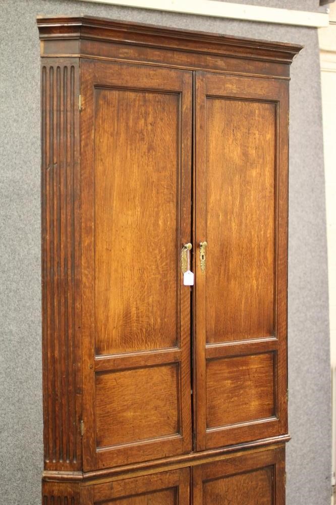 A GEORGIAN OAK STANDING CORNER CUPBOARD Image