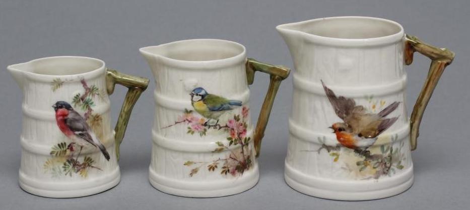 A GRADUATED SET OF THREE ROYAL WORCESTER STAVED JUGS Image