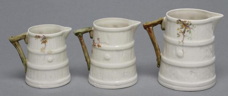 A GRADUATED SET OF THREE ROYAL WORCESTER STAVED JUGS Image