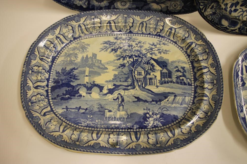 A COLLECTION OF FOUR BLUE AND WHITE PRINTED EARTHENWARE MEAT PLATES comprising "The Philosopher" Image