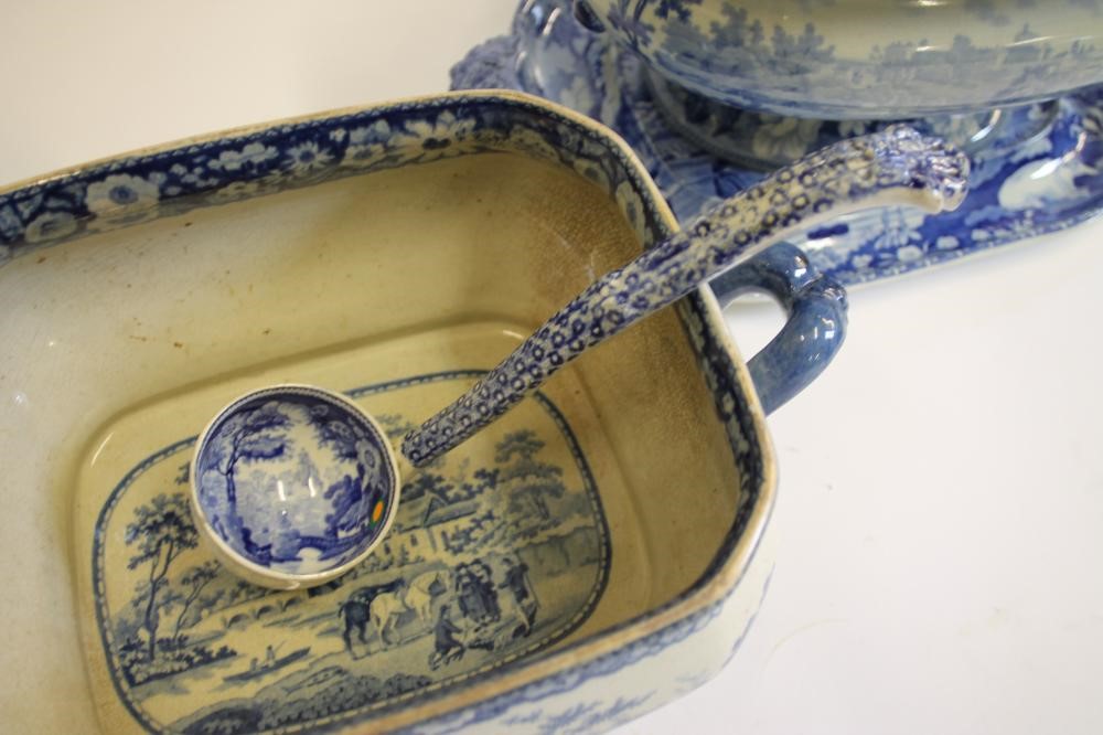 A QUANTITY OF BLUE AND WHITE PRINTED EARTHENWARE including a "Village Fisherman" tureen stand Image