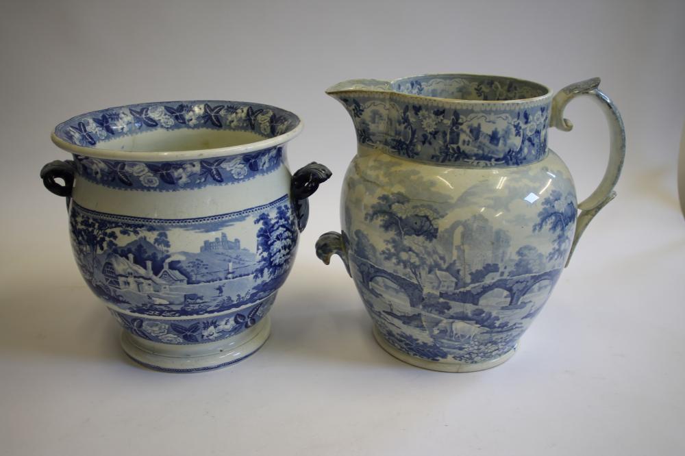 A LARGE BLUE AND WHITE PRINTED EARTHENWARE JUG of baluster form with scroll handle and lobed lug Image