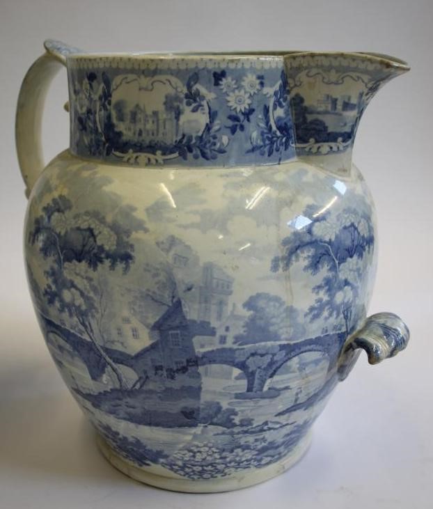 A LARGE BLUE AND WHITE PRINTED EARTHENWARE JUG of baluster form with scroll handle and lobed lug Image