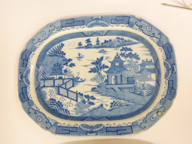 THREE BLUE AND WHITE PRINTED EARTHENWARE MEAT PLATES comprising a Davenport "Chinoiserie Ruins" Image