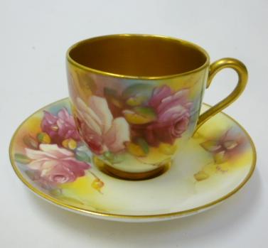 A ROYAL WORCESTER PORCELAIN MINIATURE TEACUP AND SAUCER Image