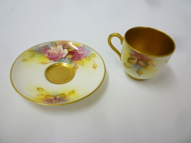 A ROYAL WORCESTER PORCELAIN MINIATURE TEACUP AND SAUCER Image