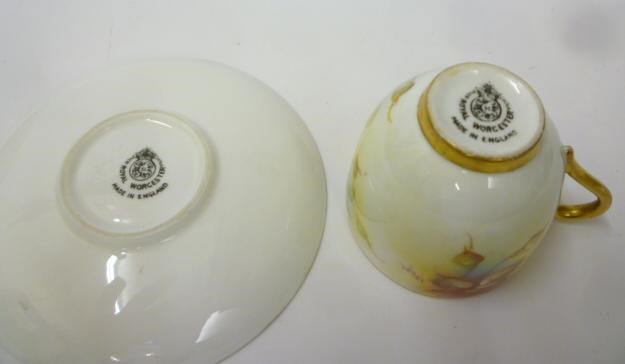 A ROYAL WORCESTER PORCELAIN MINIATURE TEACUP AND SAUCER Image