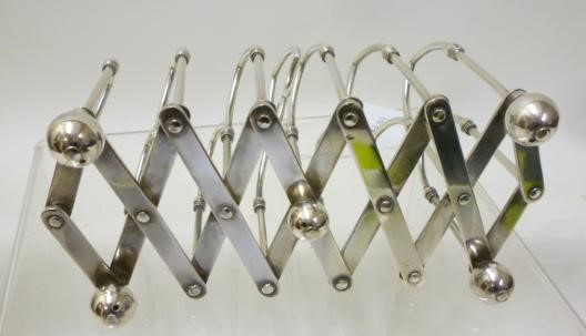 A LATE VICTORIAN SILVER PLATED CONCERTINA ACTION TOASTRACK Image