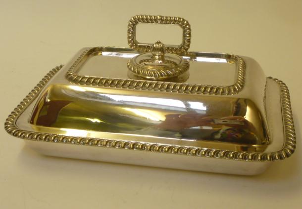 A SILVER PLATED ENTREE DISH AND COVER of rounded oblong form with gadrooned borders and detachable Image