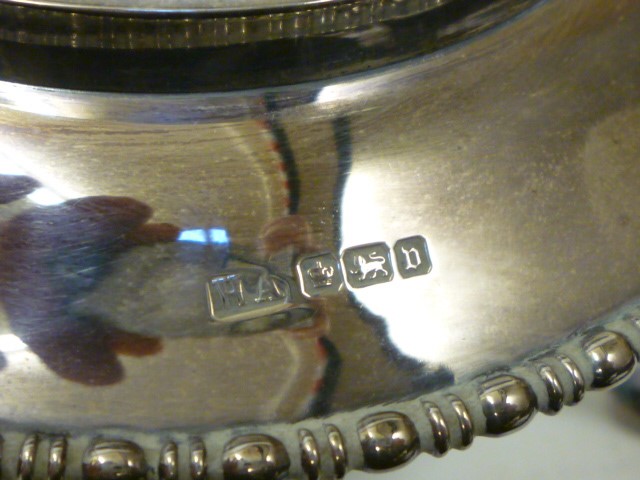 A SILVER TEA KETTLE AND BURNER ON STAND Image