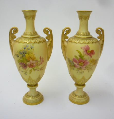 A PAIR OF ROYAL WORCESTER PORCELAIN SMALL TWO HANDLED VASES Image