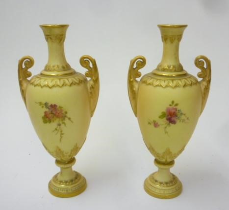 A PAIR OF ROYAL WORCESTER PORCELAIN SMALL TWO HANDLED VASES Image