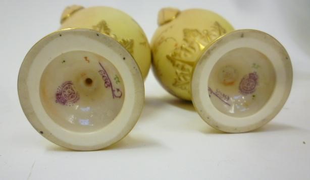 A PAIR OF ROYAL WORCESTER PORCELAIN SMALL TWO HANDLED VASES Image