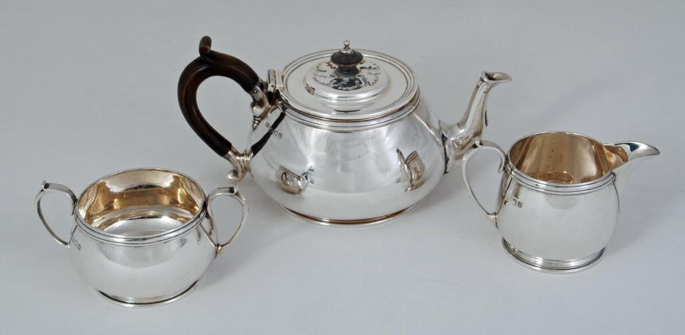 AN ARTS AND CRAFTS STYLE SILVER THREE PIECE TEA SERVICE Image
