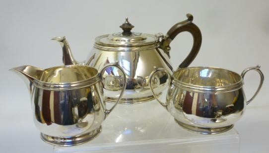 AN ARTS AND CRAFTS STYLE SILVER THREE PIECE TEA SERVICE Image