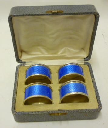 A SET OF FOUR ART DECO SILVER NAPKIN RINGS Image