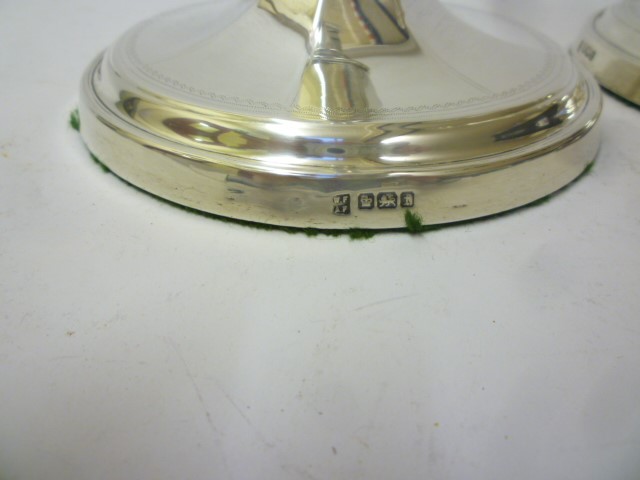 A PAIR OF EARLY GEORGE V SILVER CANDLESTICKS Image