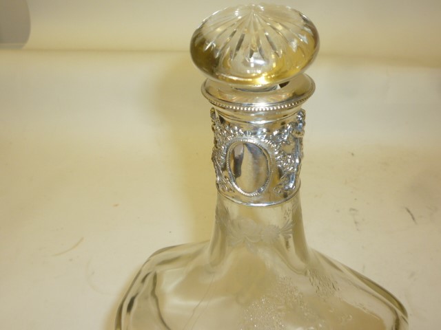 AN EDWARDIAN GLASS AND SILVER DECANTER Image