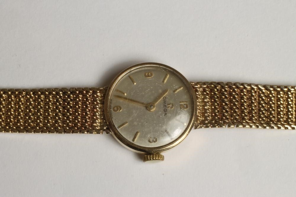A LADY'S 9CT GOLD OMEGA WRISTWATCH Image