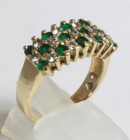 AN EMERALD AND DIAMOND HALF HOOP RING Image
