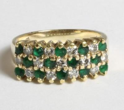 AN EMERALD AND DIAMOND HALF HOOP RING Image