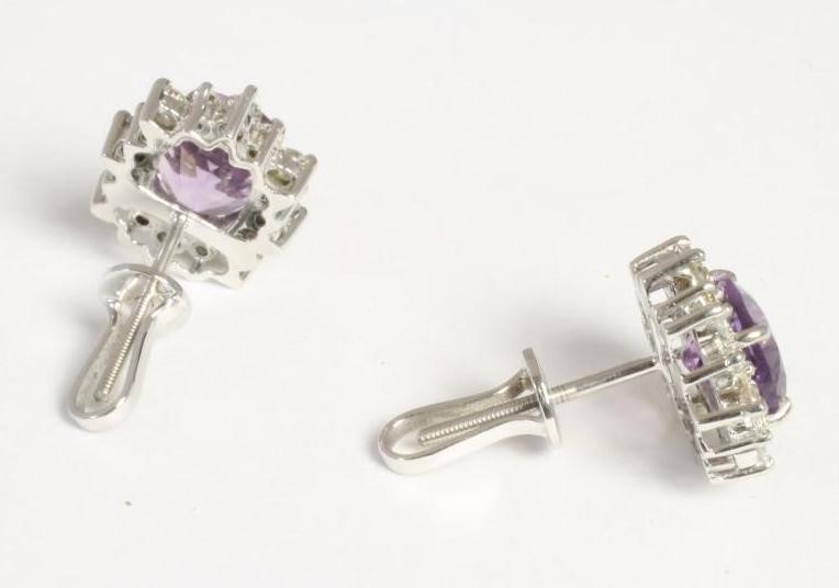 A PAIR OF AMETHYST AND DIAMOND CLUSTER EAR STUDS Image