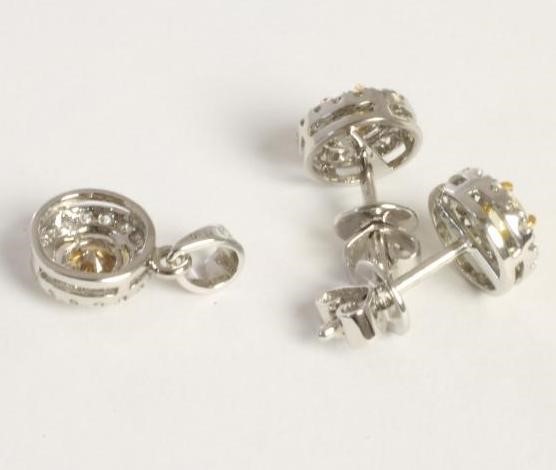 A FANCY YELLOW DIAMOND PENDANT AND MATCHING STUD EARRINGS Image