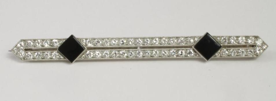A DIAMOND AND BLACK ONYX ART DECO STYLE DOUBLE BAR BROOCH Image