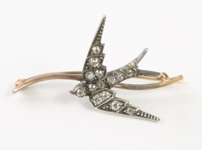A VICTORIAN DIAMOND BROOCH modelled as a swallow in flight Image
