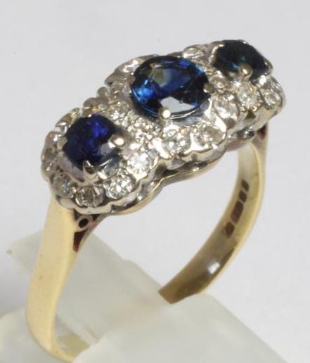 A THREE STONE SAPPHIRE AND DIAMOND HALF HOOP RING Image