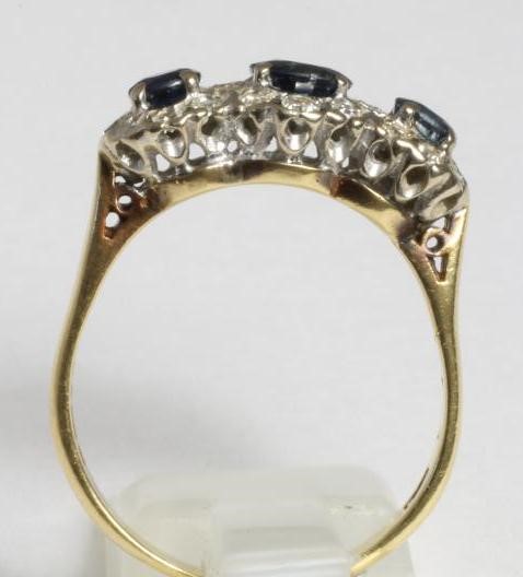 A THREE STONE SAPPHIRE AND DIAMOND HALF HOOP RING Image