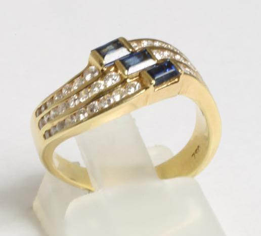 A SAPPHIRE AND DIAMOND HALF HOOP RING Image